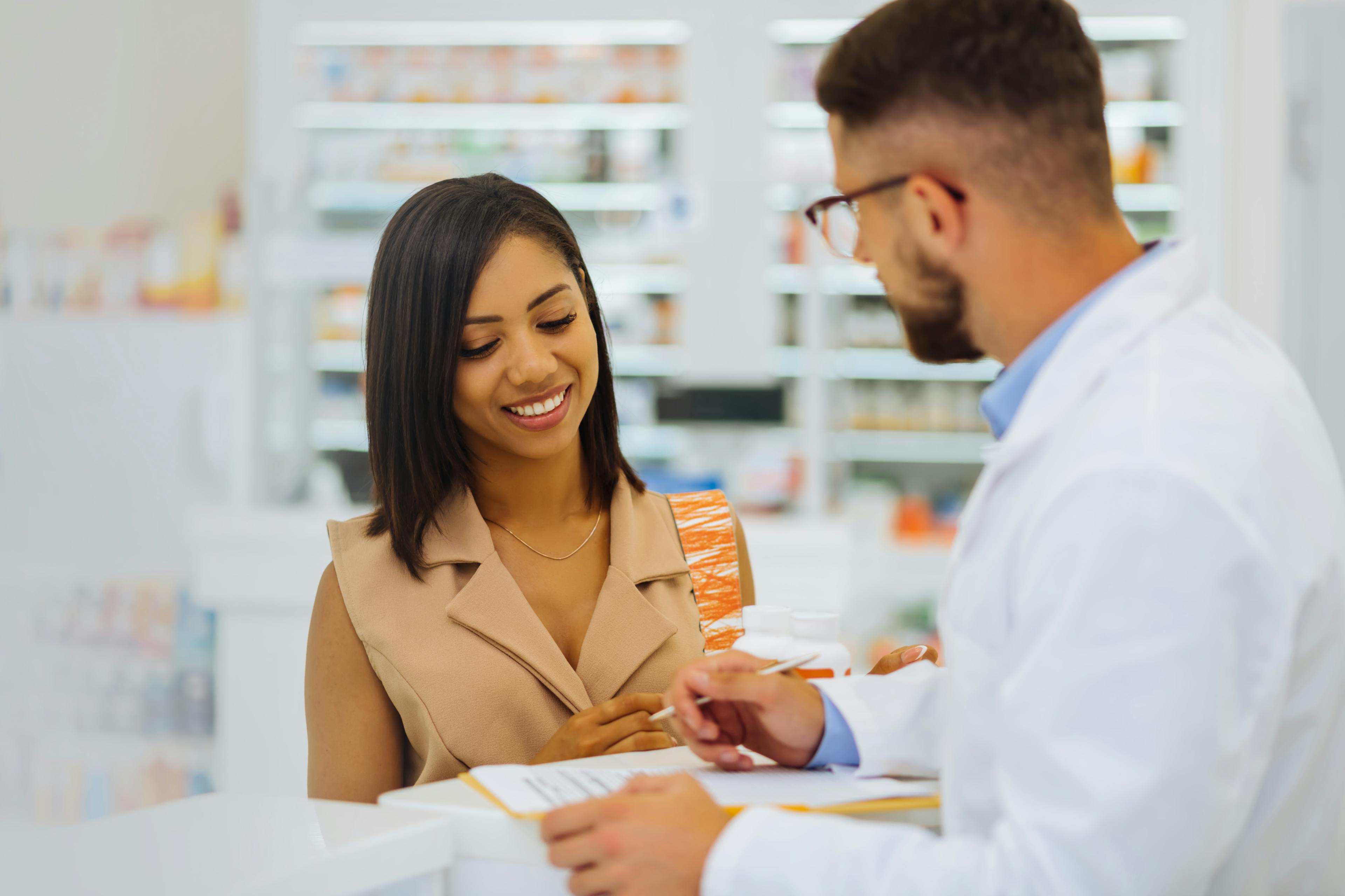 Dark-haired female. Cheerful girl expressing positivity while looking at prescription
